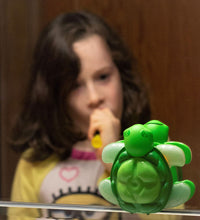 Load image into Gallery viewer, child brushing teeth looking at green turtle timer in mirror